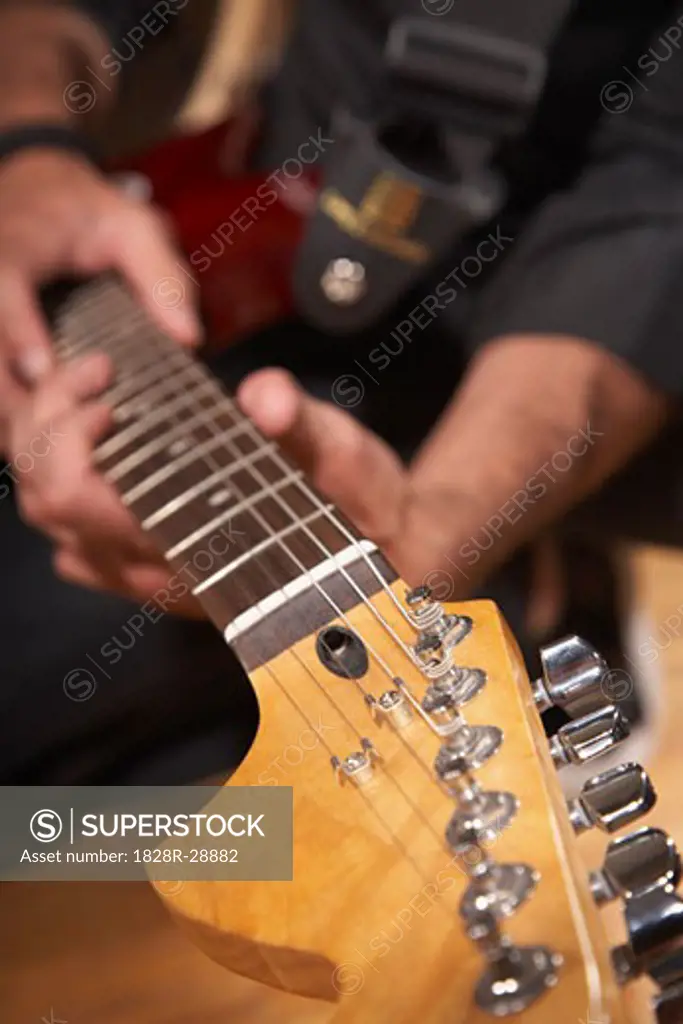 Person Playing Guitar   