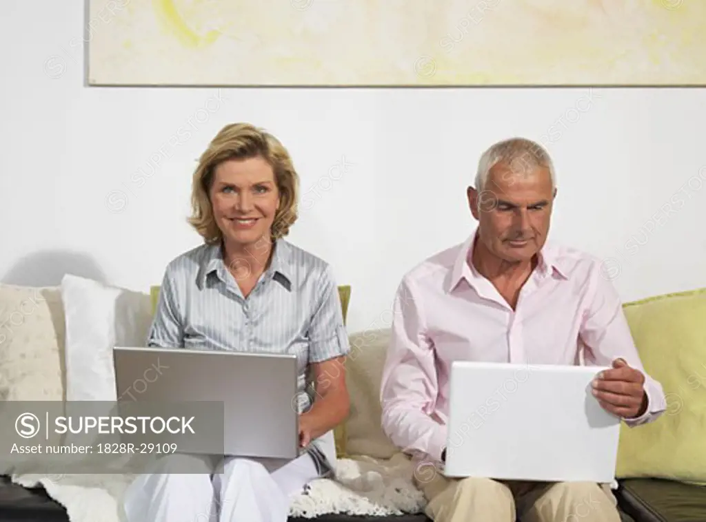 Couple Using Laptops   