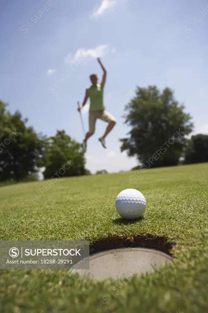 Golfer Jumping in Air   