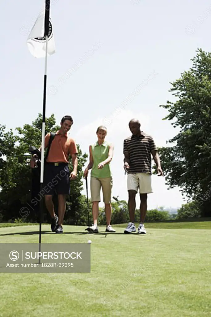 Golfers Walking on Putting Green   