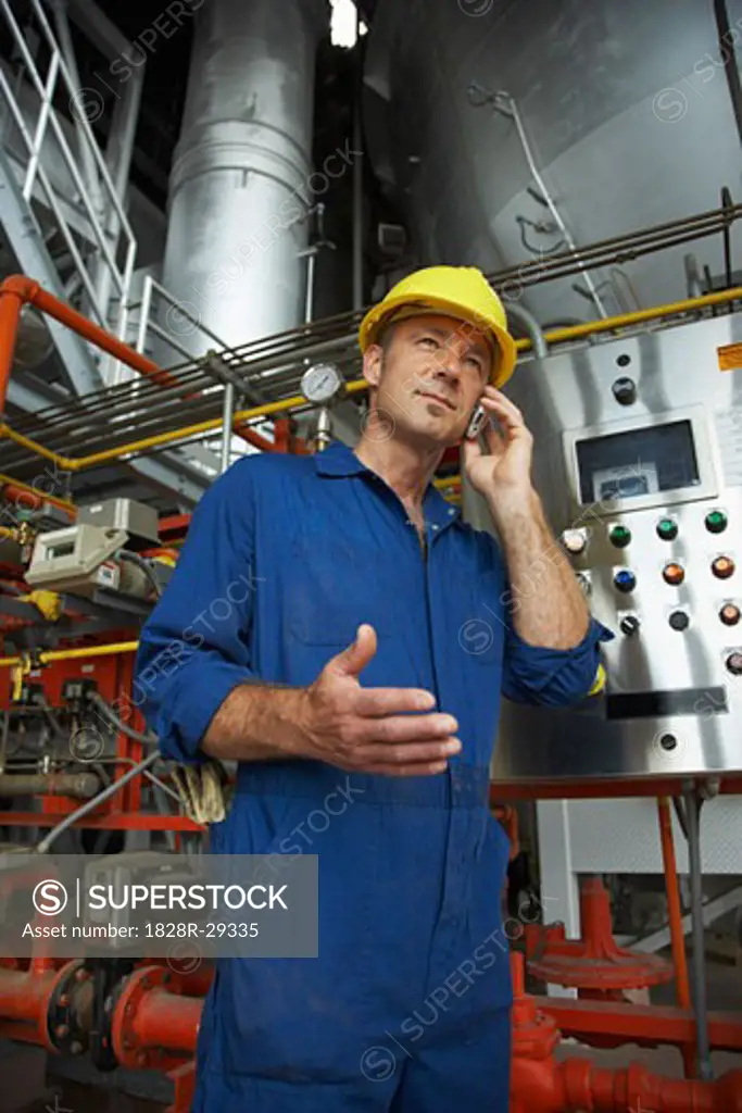 Worker at Water Treatment Plant with Cellular Phone   