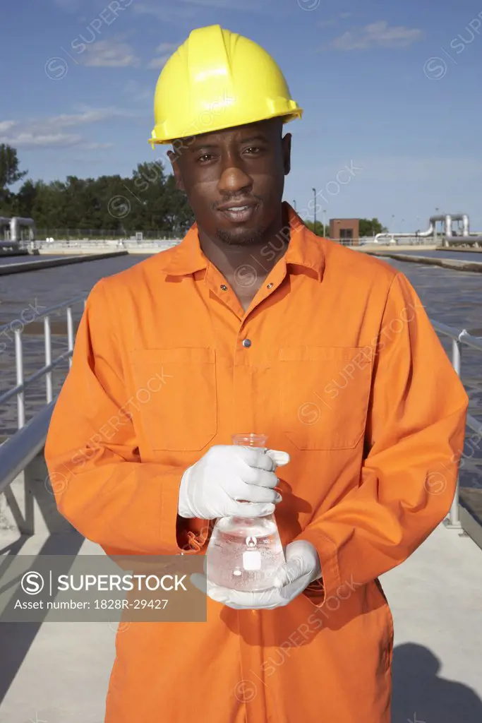Man with Water Sample at Water Treatment Plant   