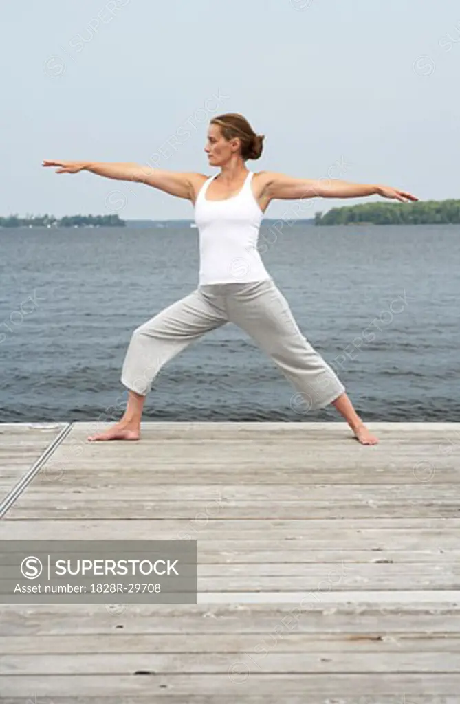 Woman Practicing Yoga on Dock   