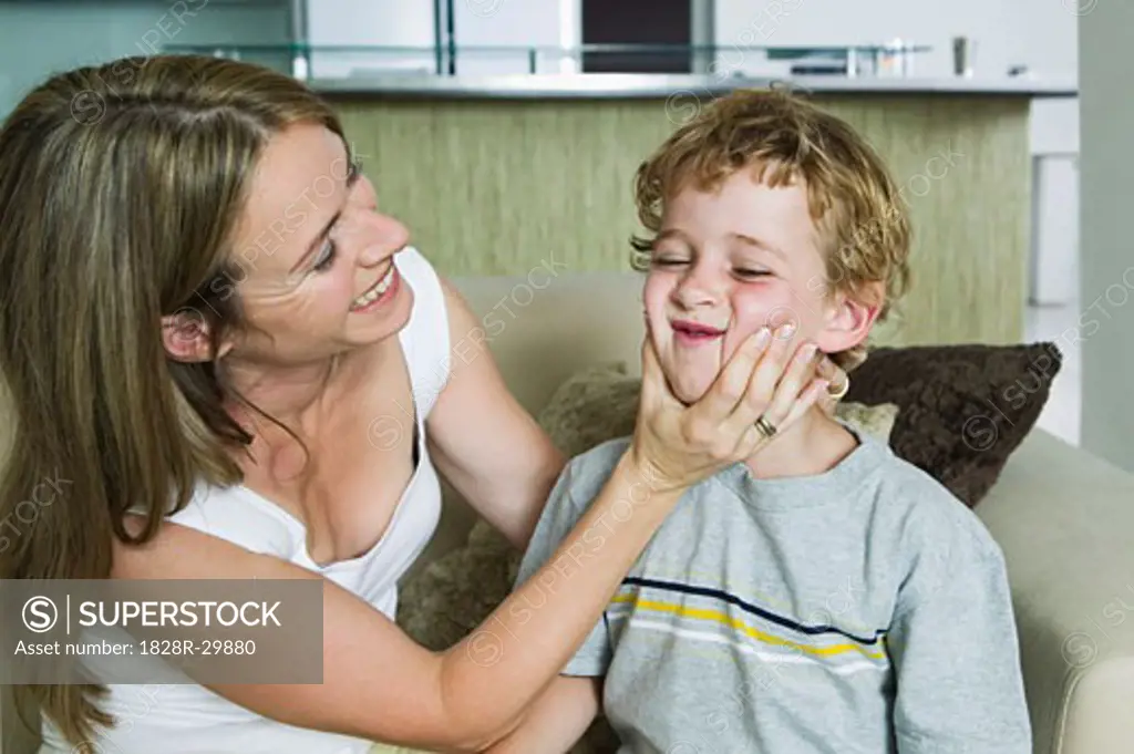 Mother Squeezing Son's Cheeks   