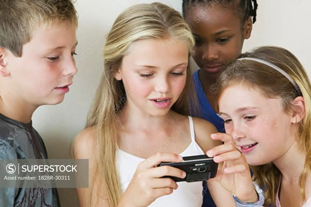 Kids Reading Text Messages on Cell Phone   
