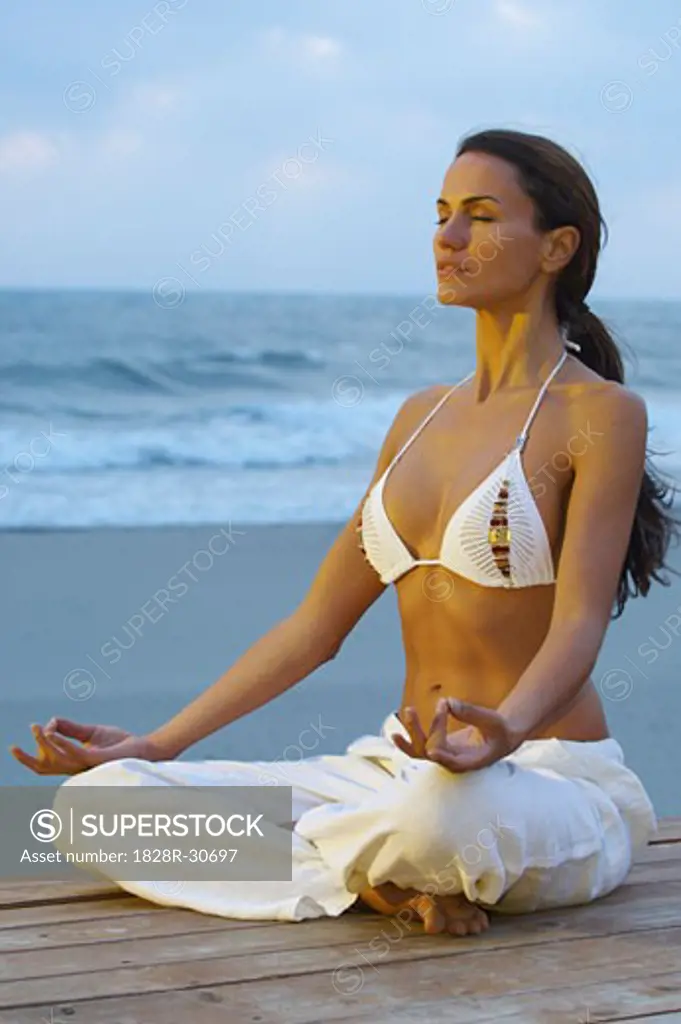 Woman Doing Yoga at Beach   