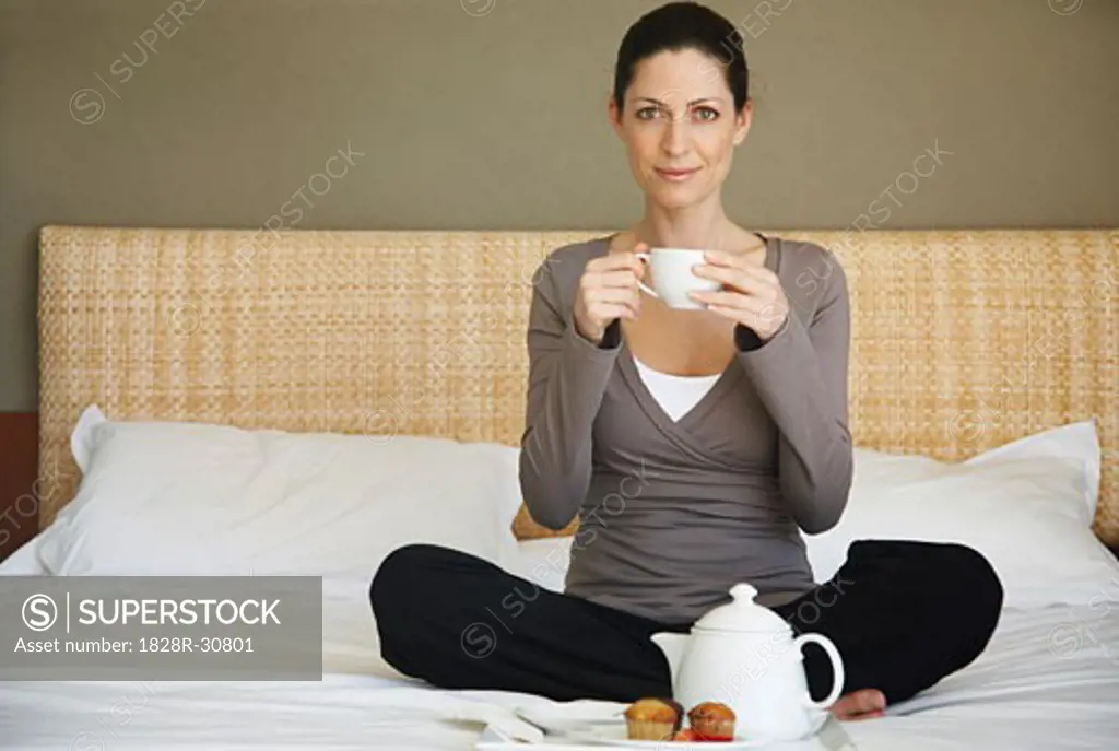 Woman Having Tea on Bed   