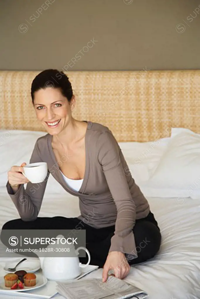 Woman Drinking Tea on Bed   