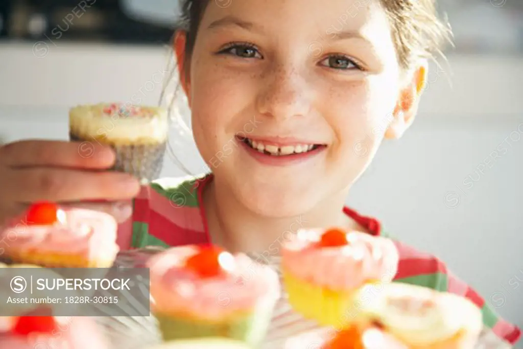 Little Girl Holding Cupcake   