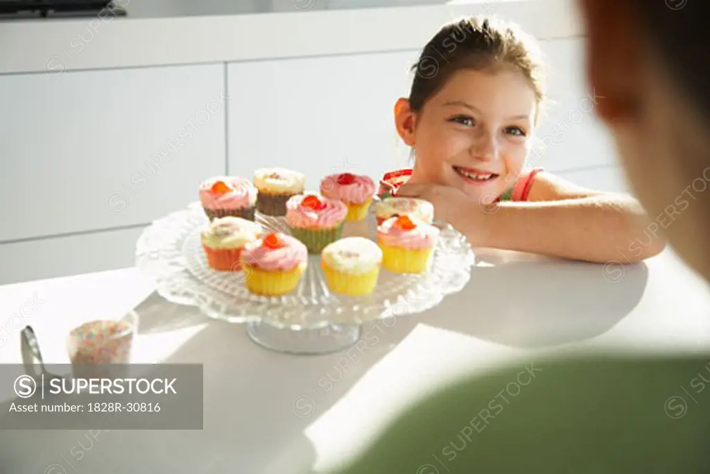 Daughter and Mother in Kitchen with Cupcakes   