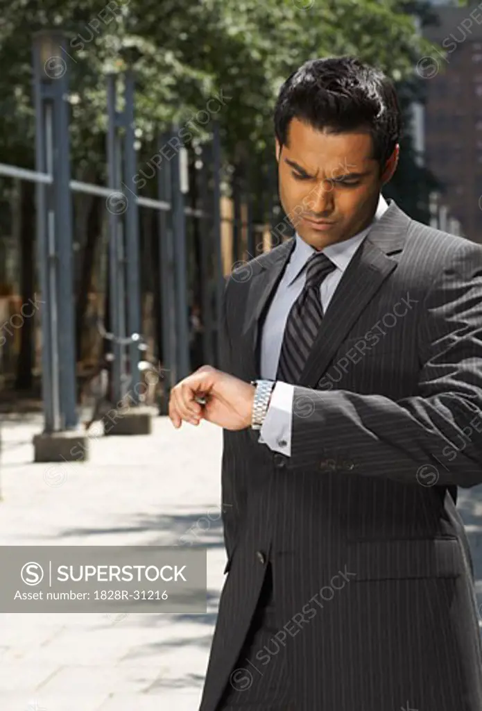 Businessman Looking at Watch   