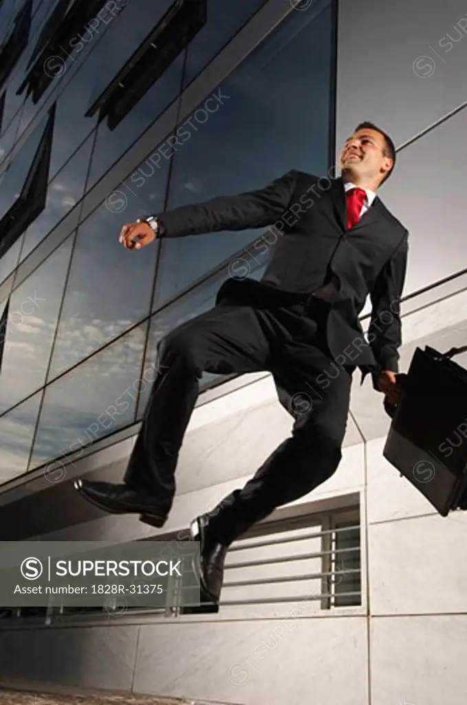 Excited Businessman Jumping   