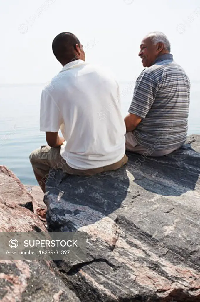 Father and Son on Rocks by Water   