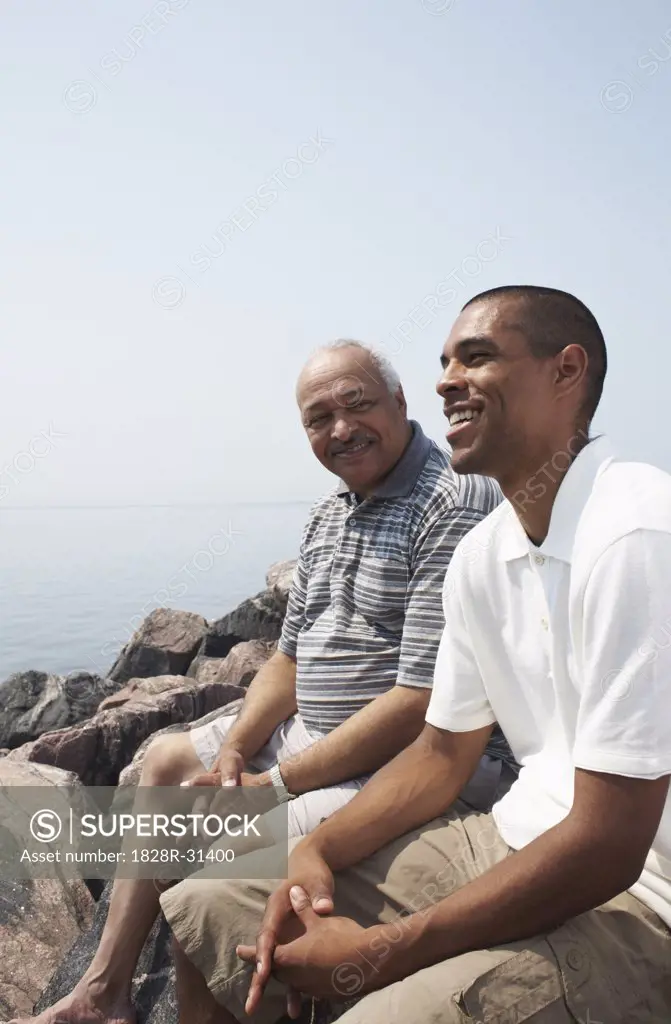 Father and Son on Rocks by Water   