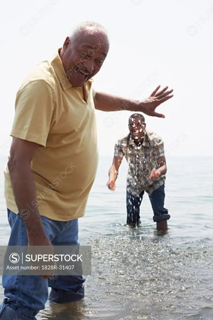 Father and Son Playing in Water   