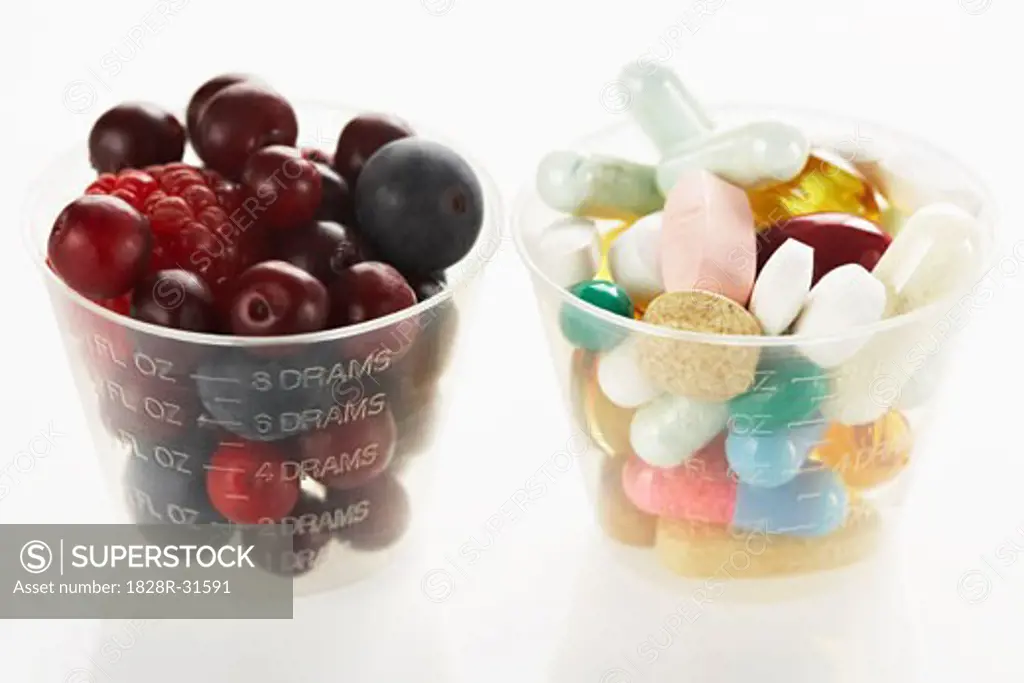 Berries and Pills in Medicine Cups   