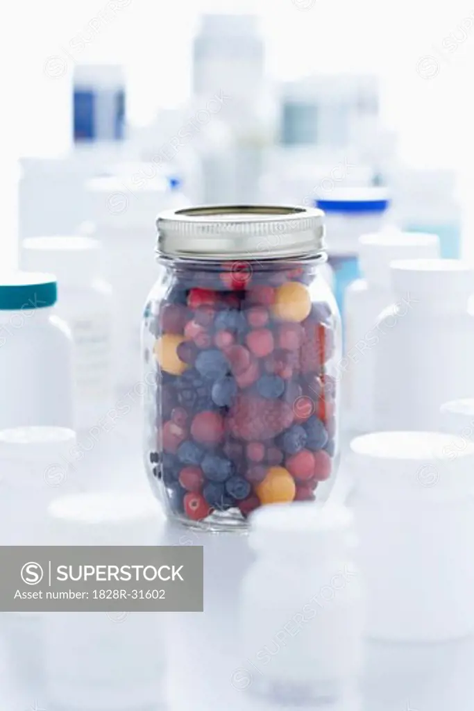 Jar Of Berries and Pill Bottles   