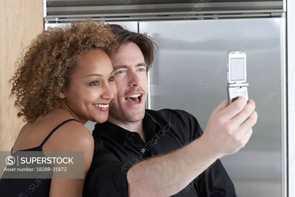 Couple Taking Pictures of Themselves With Camera Phone   