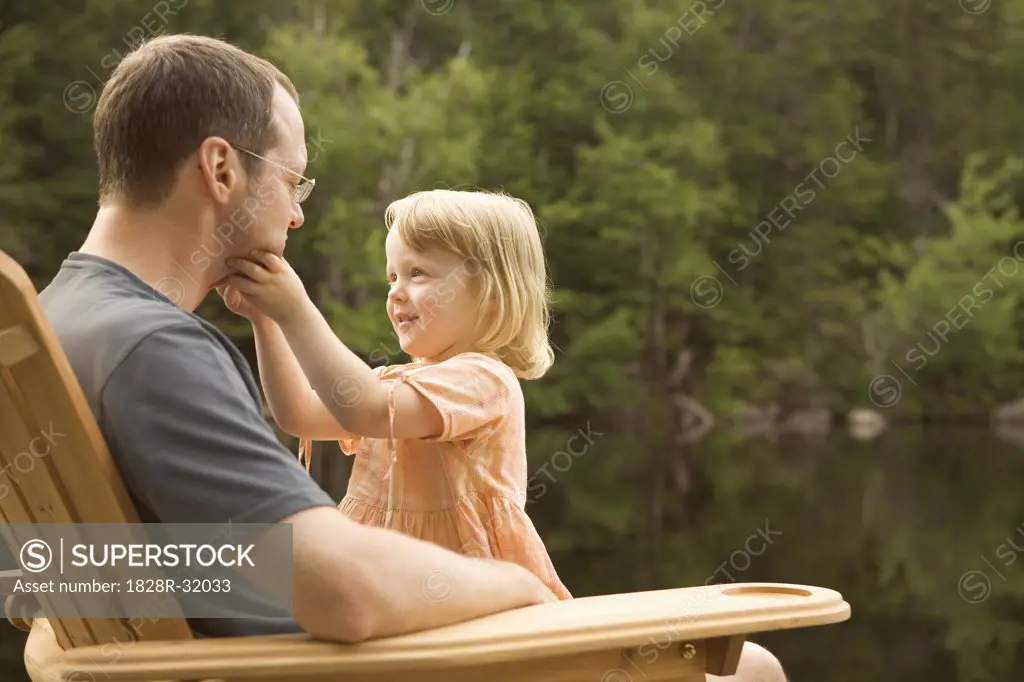 Father and Daughter on Dock by Lake   
