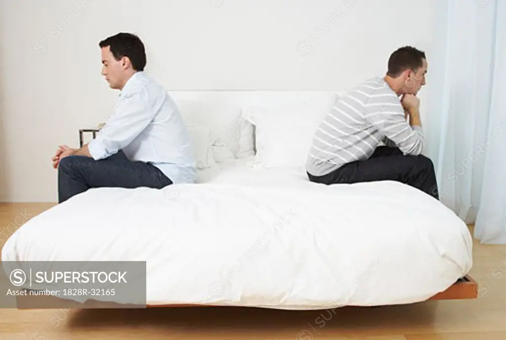 Couple Sitting on Bed   