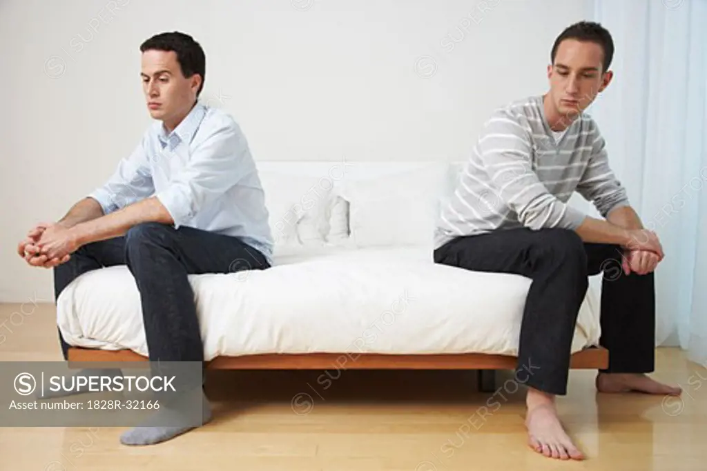 Couple Sitting on Bed   