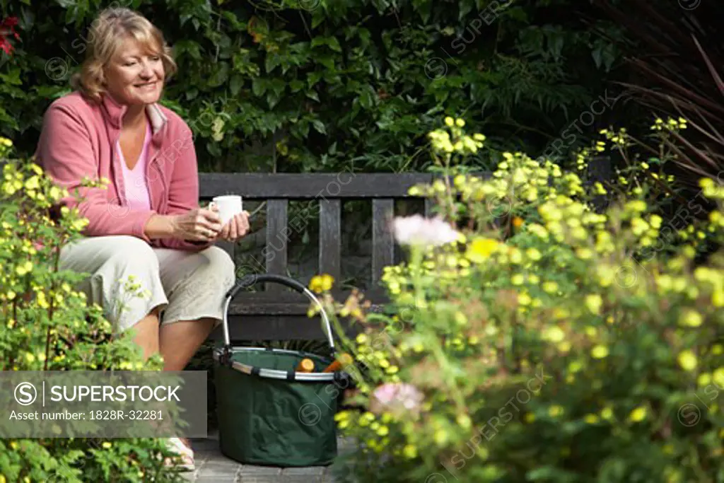 Woman Sitting in Garden   