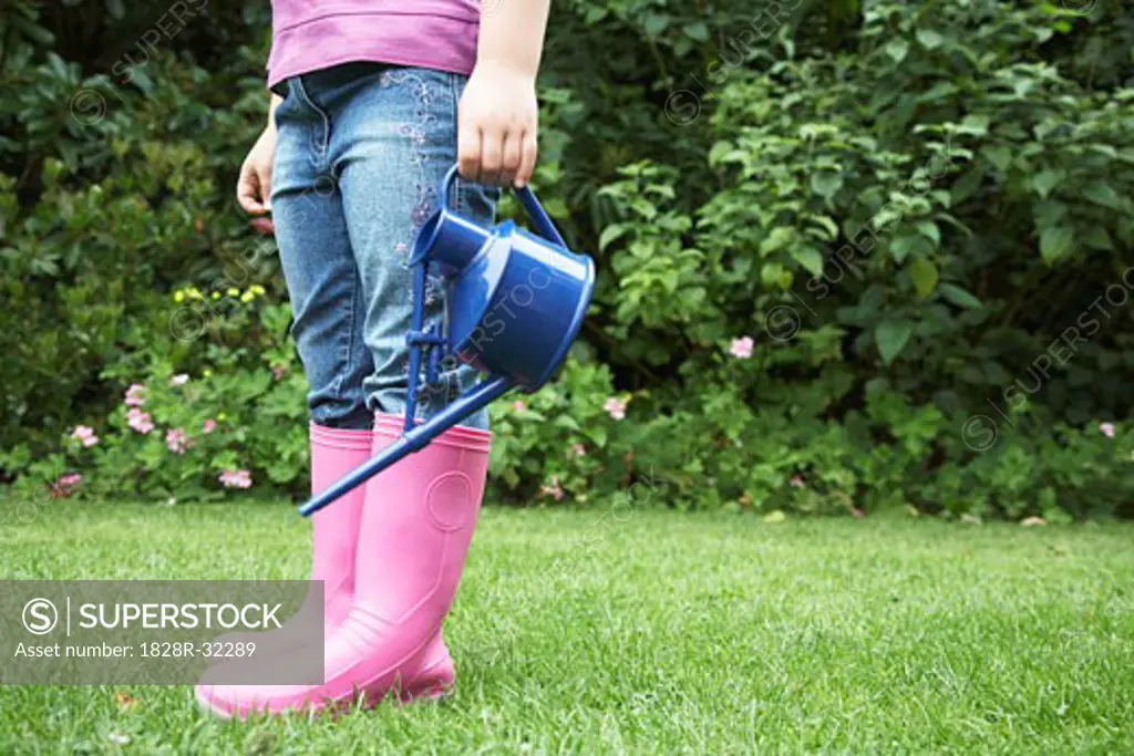 Little Girl Holding Watering Can   