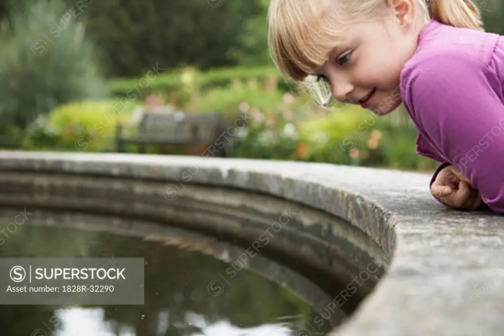 Little Girl Looking into Water   
