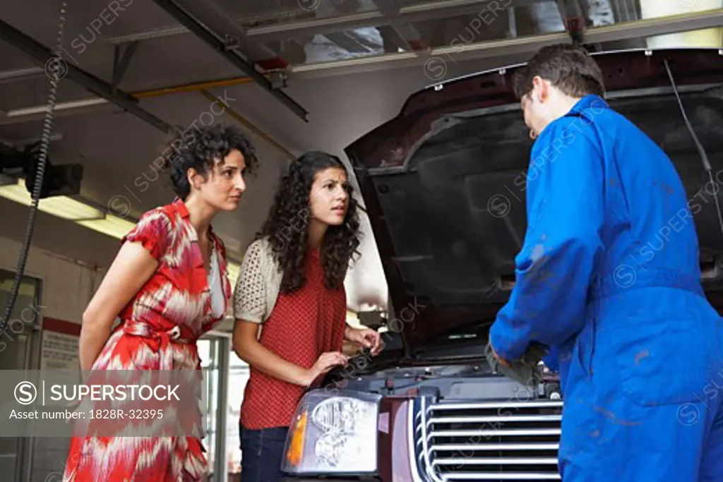 Women and Mechanic in Service Station   