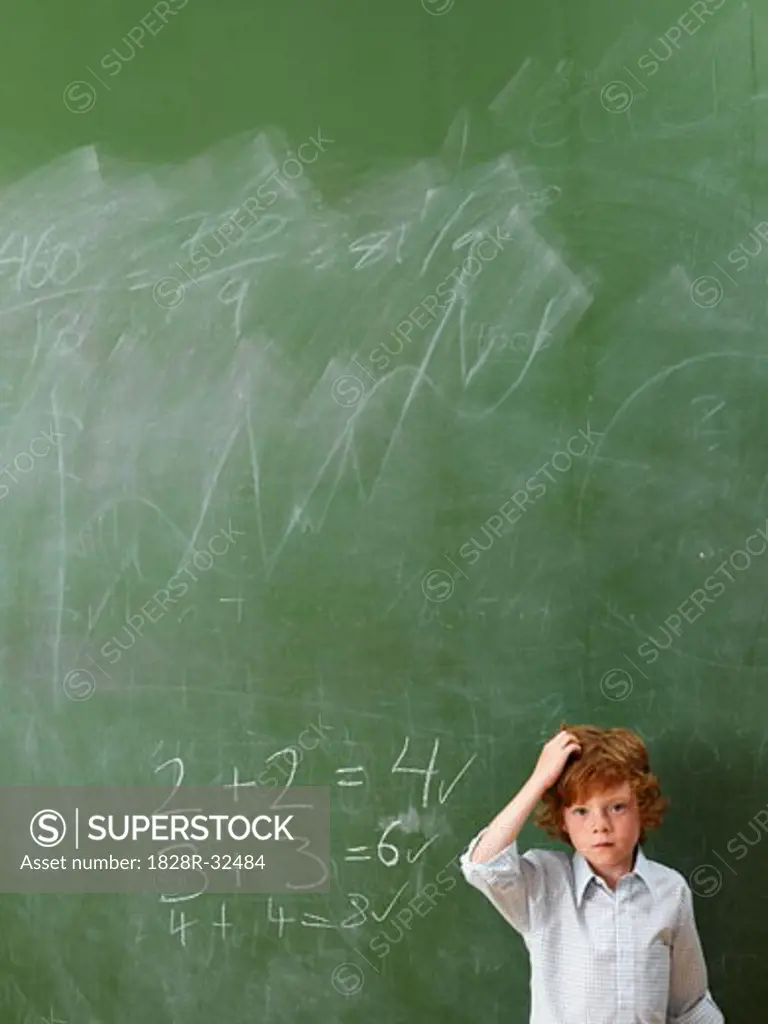 Boy Standing at Blackboard   