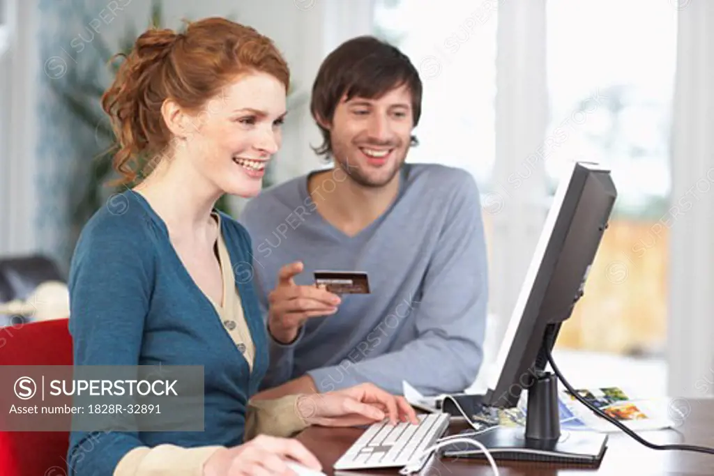 Couple with Credit Card and Computer   