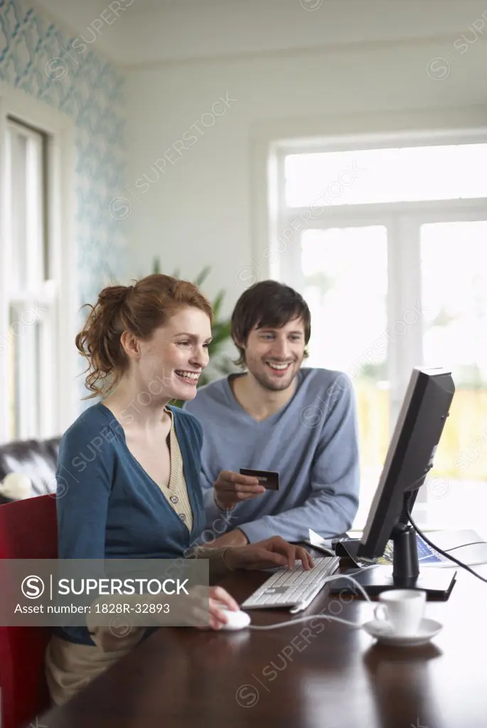 Couple with Credit Card and Computer   