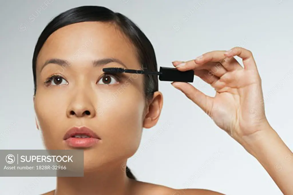 Portrait of Woman Applying Makeup   