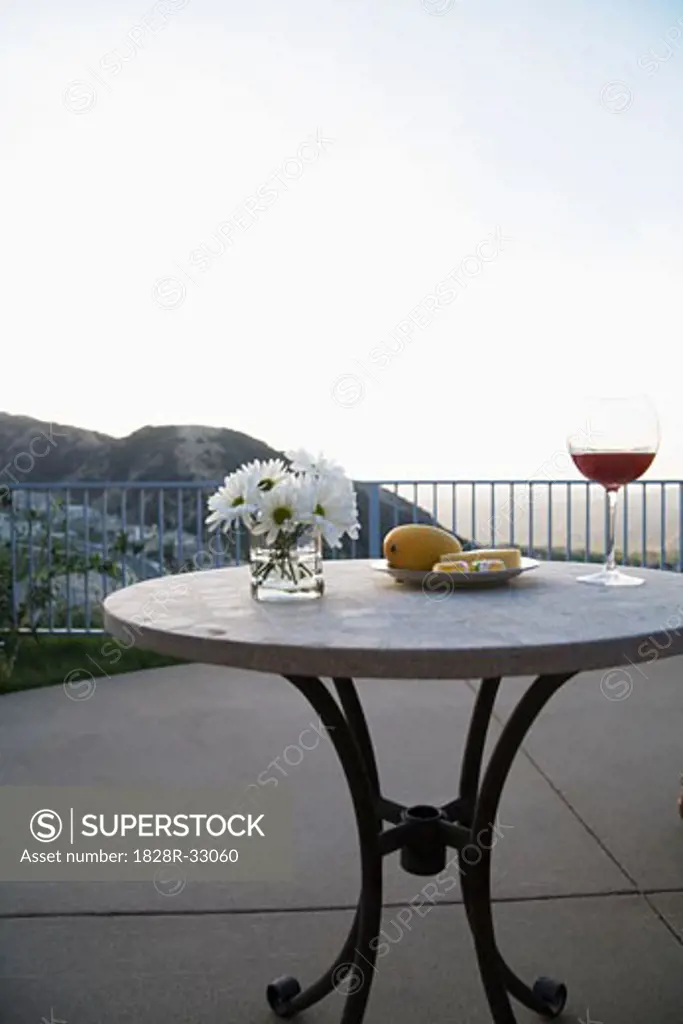 Table with Flowers, Fruit and Wine on Patio   