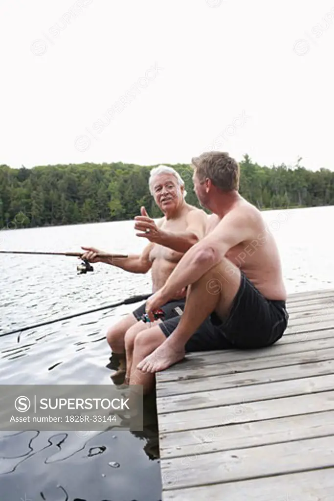 Father and Son Fishing on Dock   