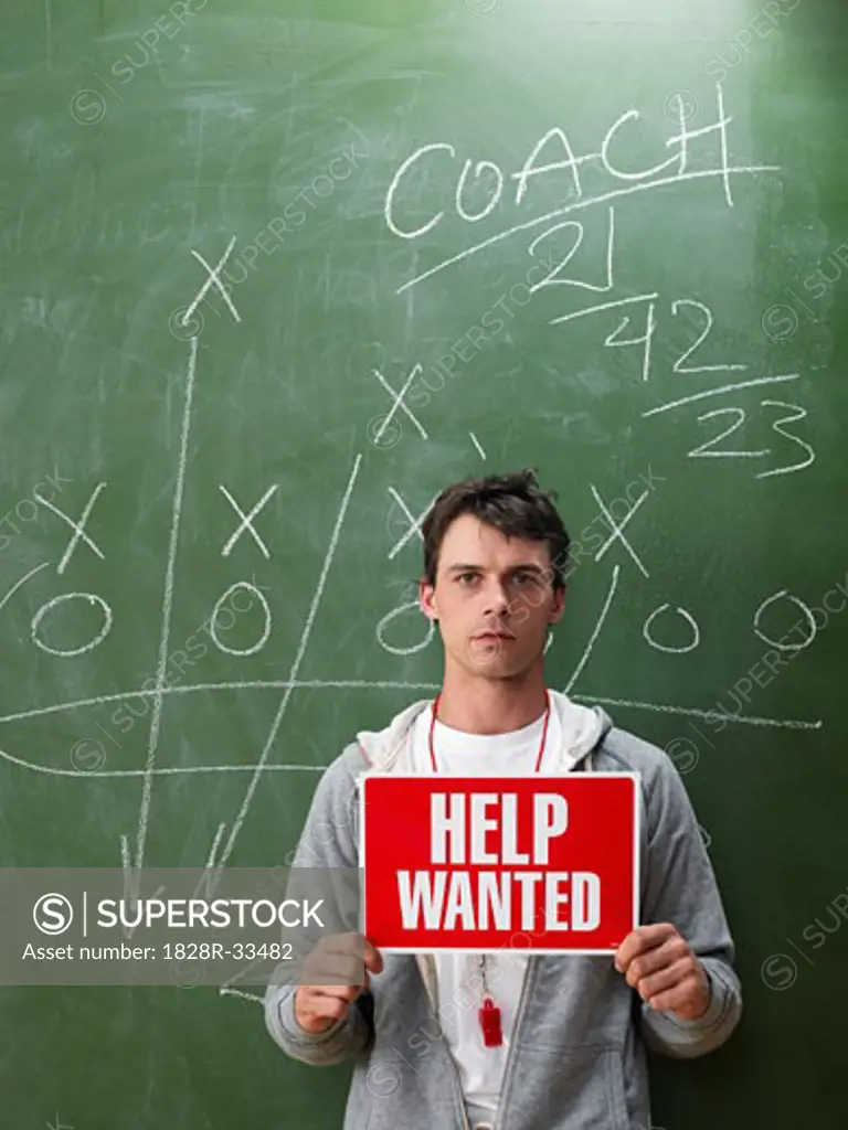 Coach Holding Help Wanted Sign   