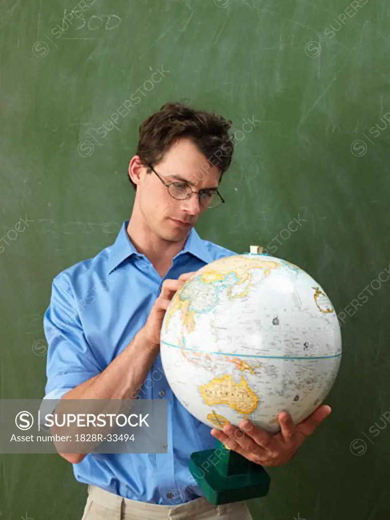 Teacher Looking at Globe   