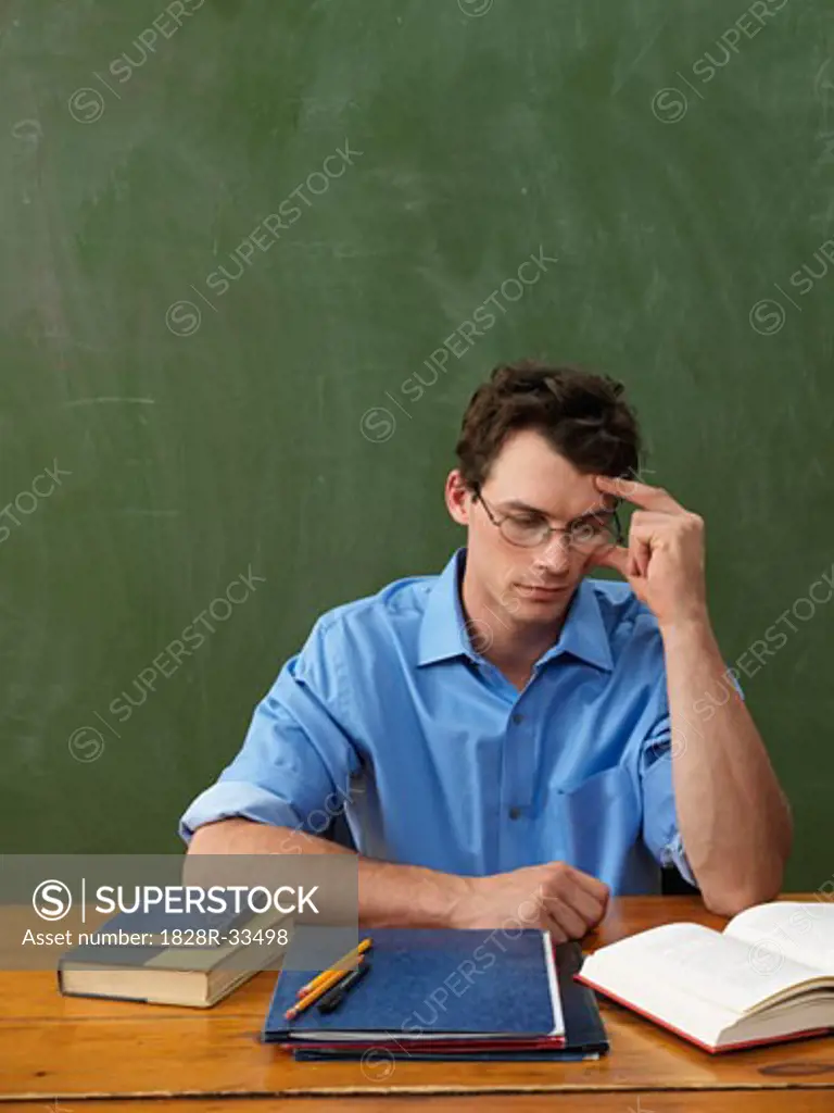 Teacher Reading at Desk   