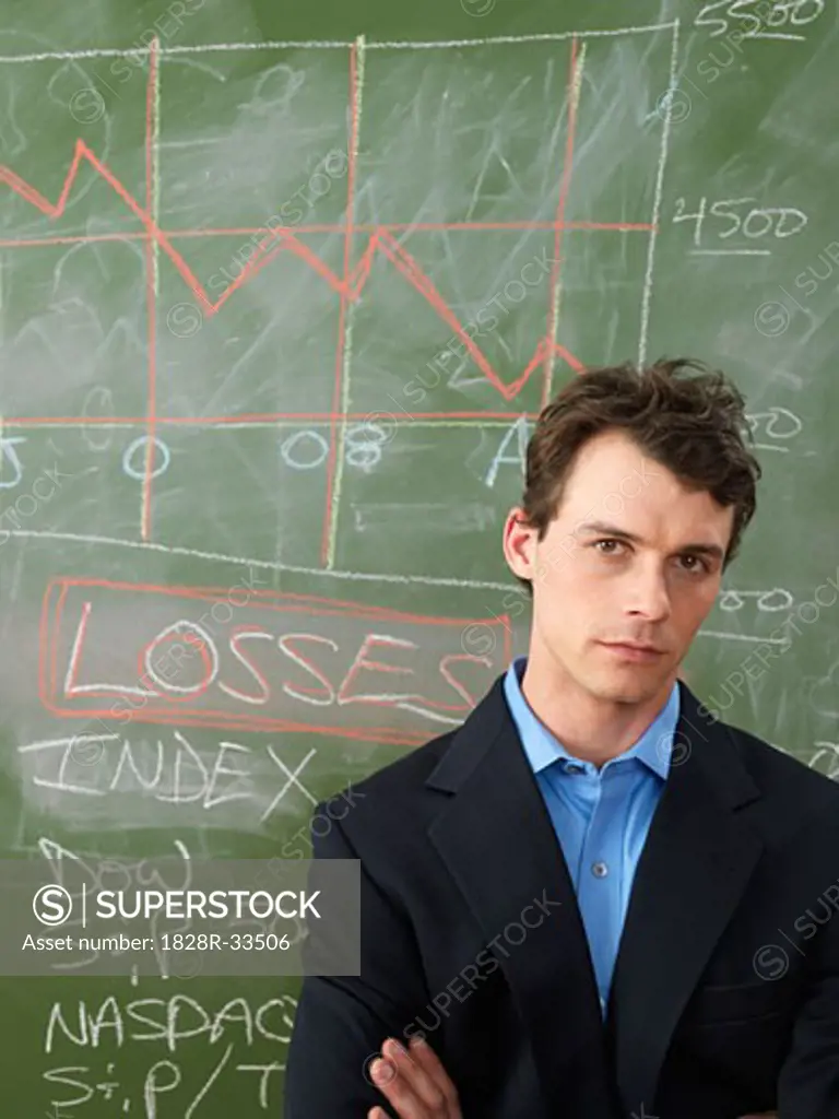 Businessman in Front of Blackboard   