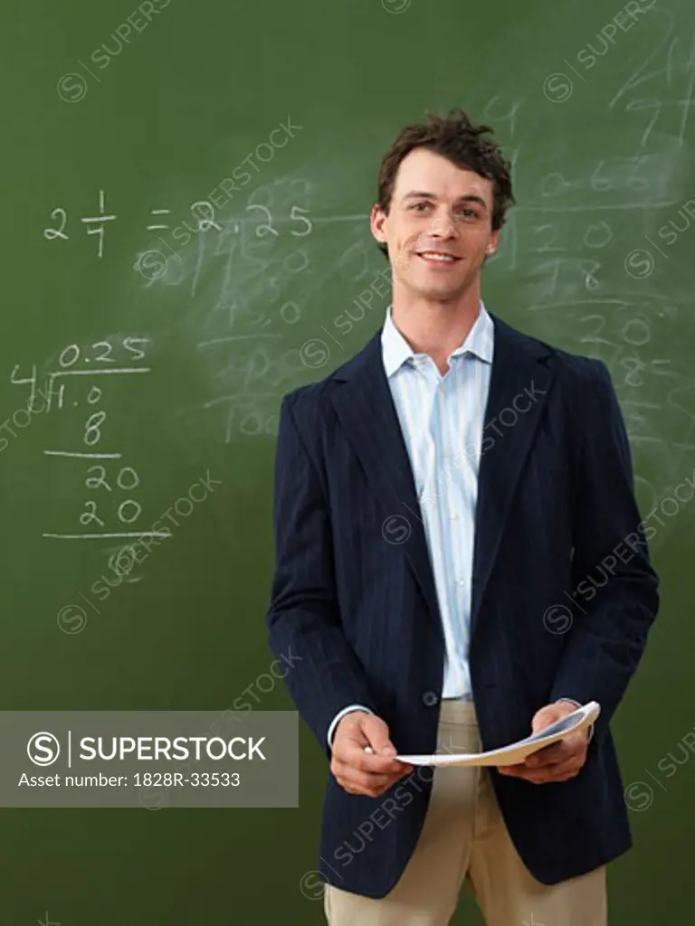 Teacher Standing in Front of Blackboard   