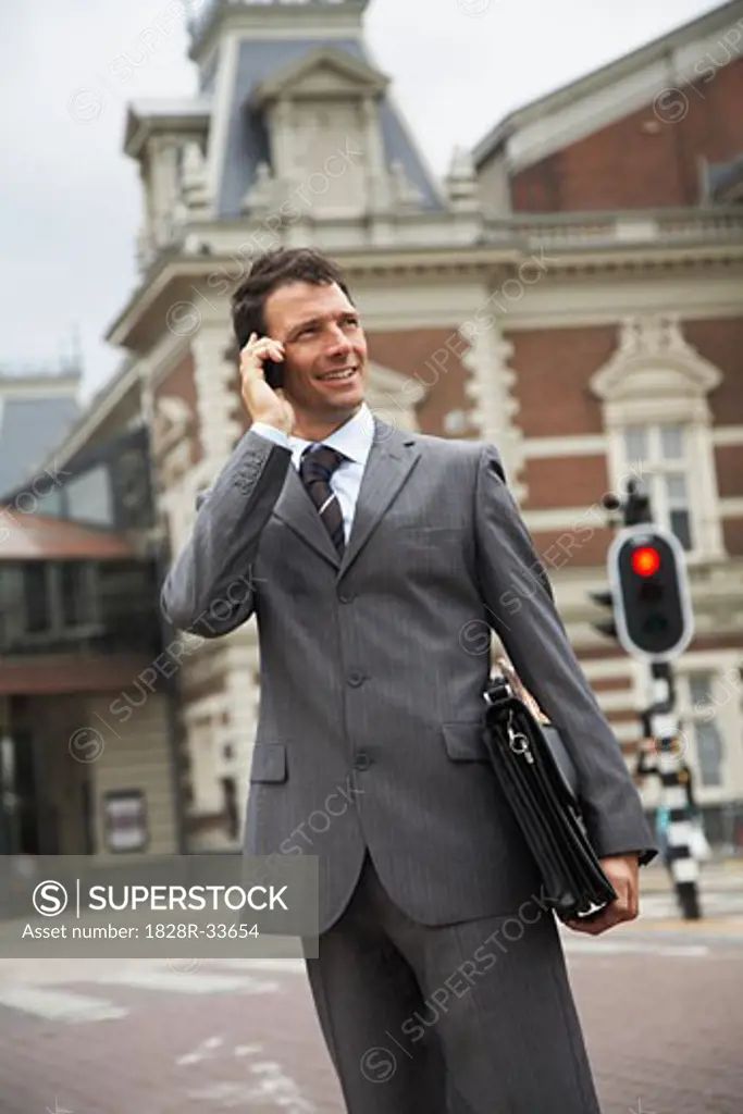 Businessman in Street with Cellular Phone, Amsterdam, Netherlands   