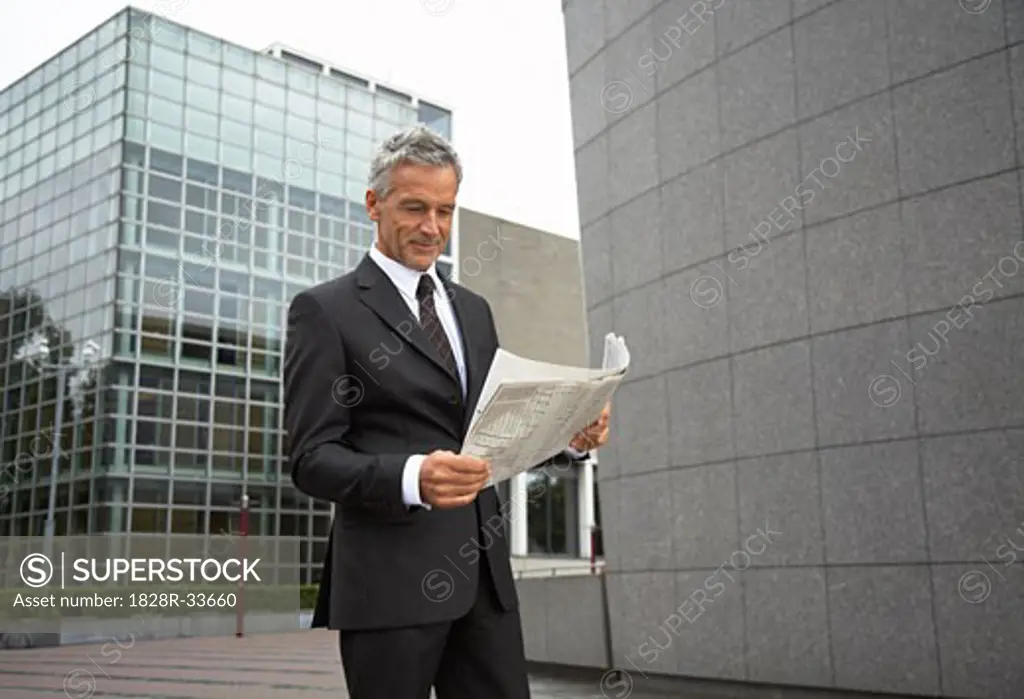 Businessman Reading Newspaper, Amsterdam, Netherlands   