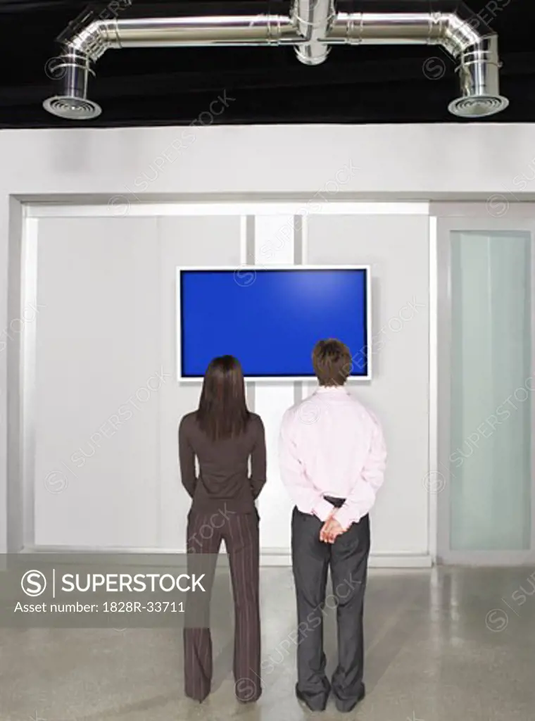 Business People Looking at Big Big Screen Television   