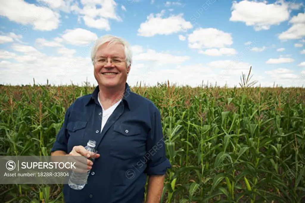 Farmer by Corn Field   