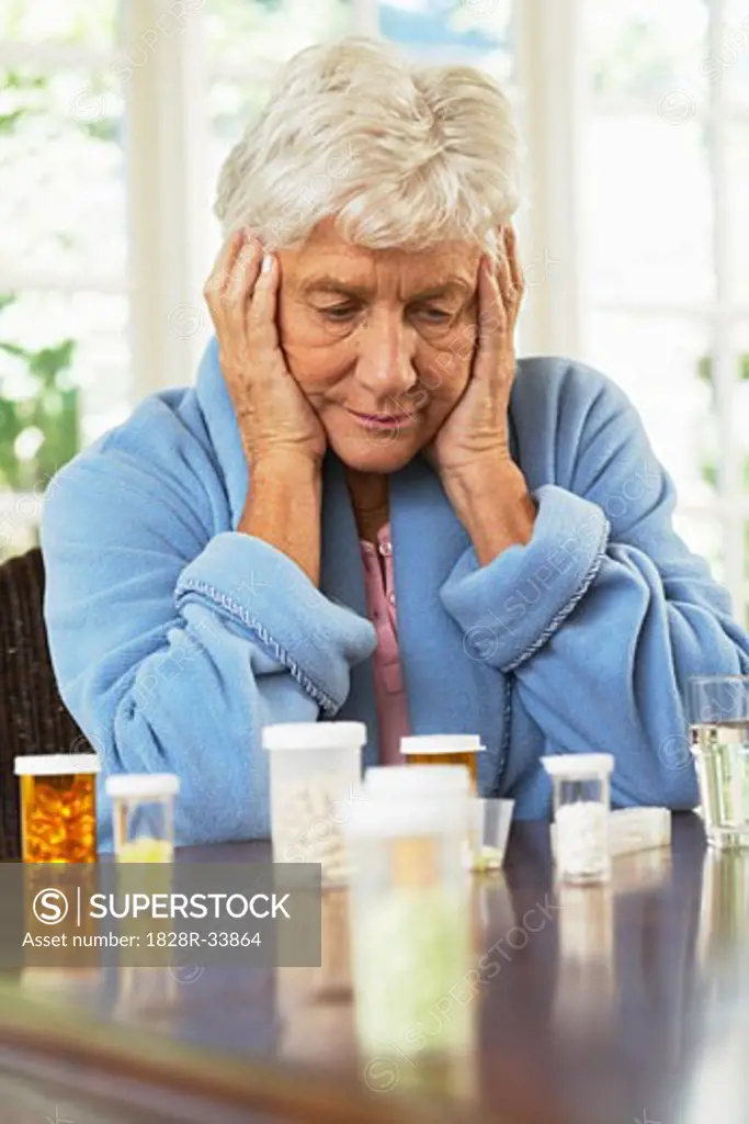 Senior Woman Looking at Pill Bottles   