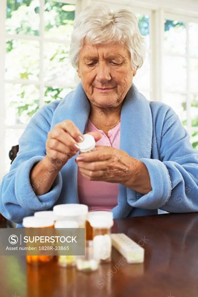 Senior Woman Looking at Pill Bottle Label   