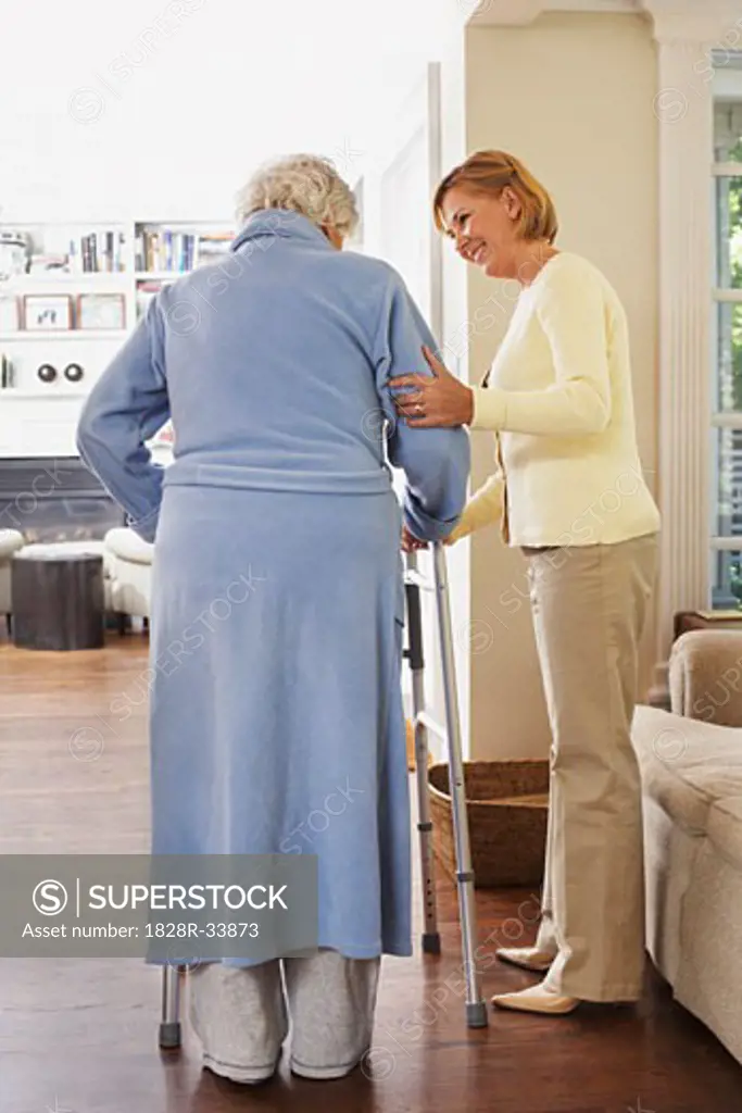 Senior Woman Receiving Assistance with Using Walker   