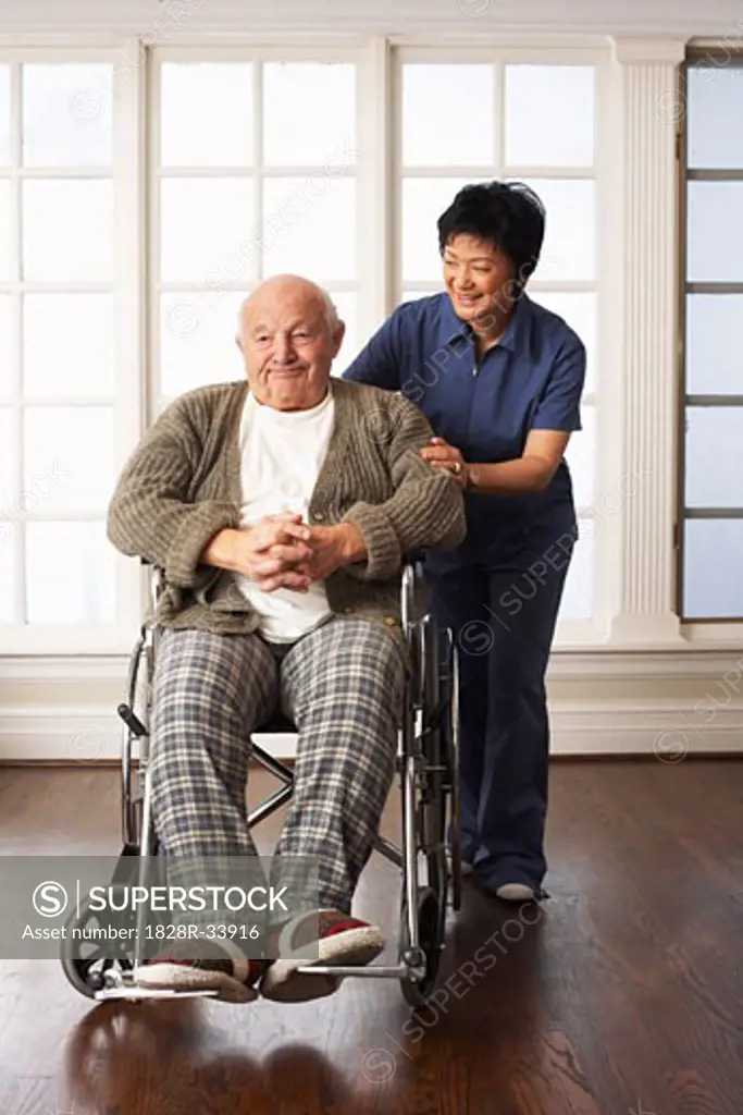 Senior Man Receiving Assistance with Wheelchair   