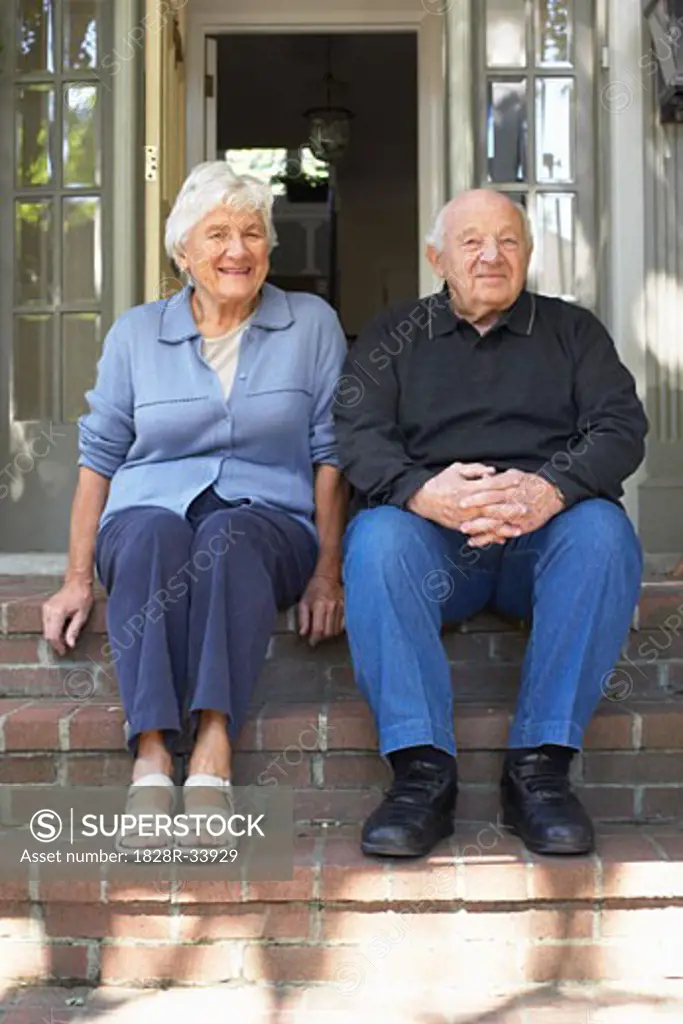 Portrait of Senior Couple Sitting on Doorstep
