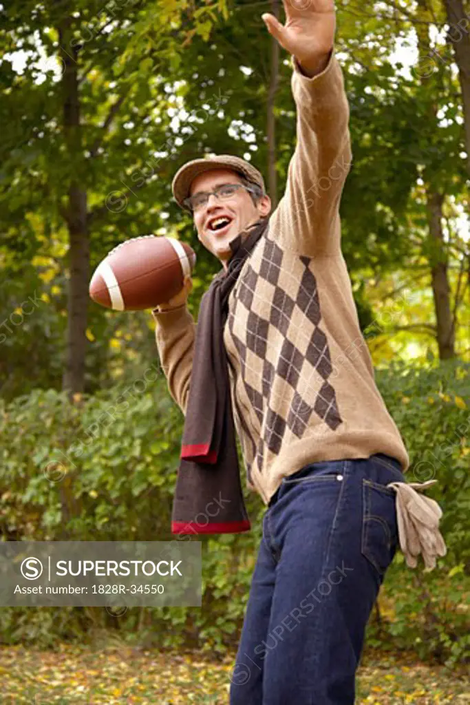 Portrait of Man Throwing American Football, in Autumn   